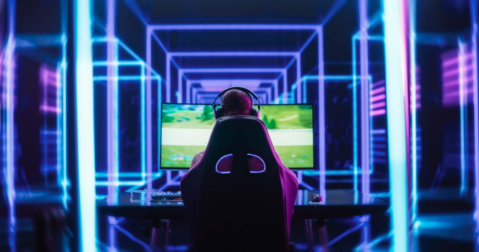 Female Online Gamer Playing Video Game in a Futuristic Cyberpunk Room. Footage From the Back of a Girl Putting On Headphones. Pro Gamer Winning an Intense eSports Tournament